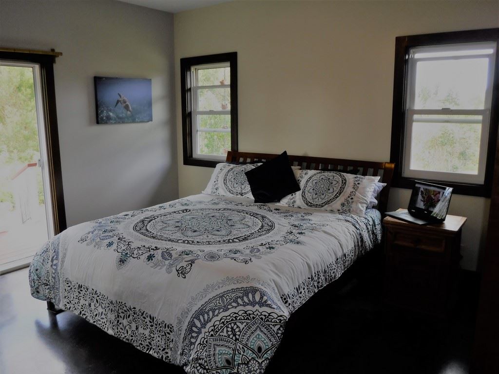1209 West Kuiaha Road, Unit 2 Haiku, HI 96708 - Photo 5 of 30 a bedroom with a bed and window