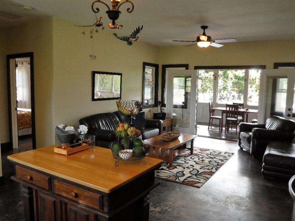 1209 West Kuiaha Road, Unit 2 Haiku, HI 96708 - Photo 7 of 30 a living room with furniture a chandelier and a dining table