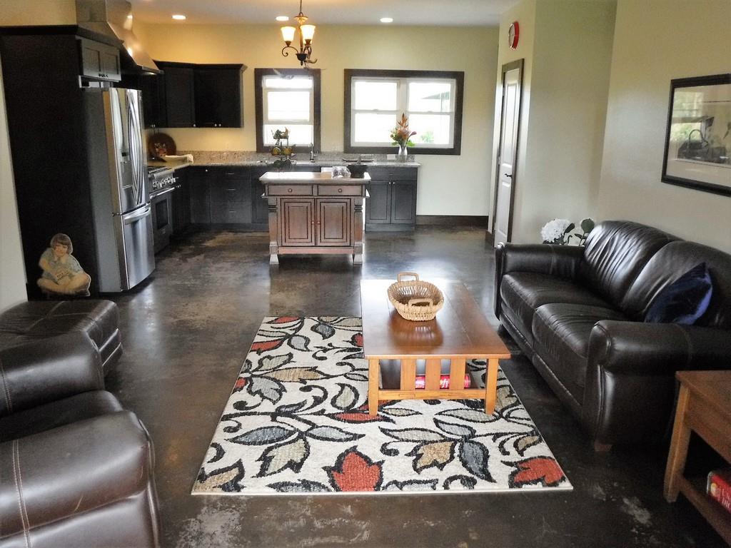 1209 West Kuiaha Road, Unit 2 Haiku, HI 96708 - Photo 8 of 30 a living room with furniture and a flat screen tv