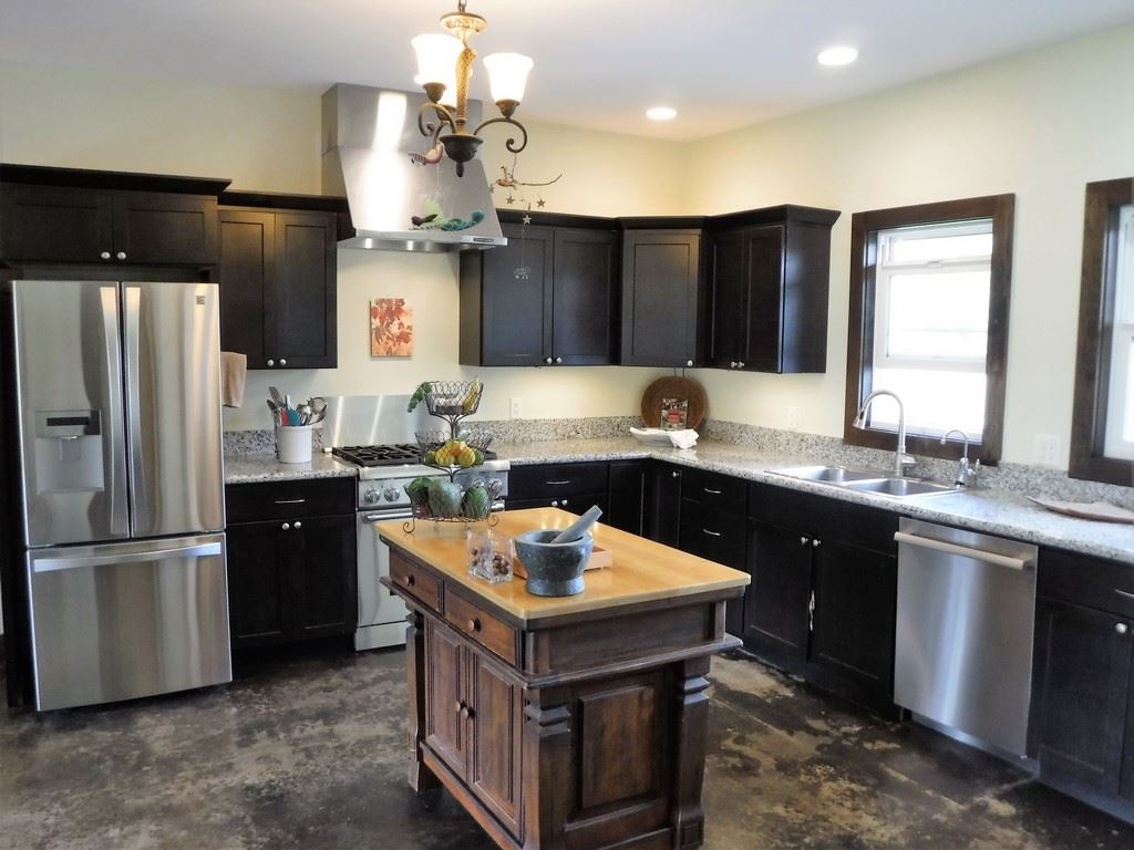 1209 West Kuiaha Road, Unit 2 Haiku, HI 96708 - Photo 9 of 30 a kitchen with granite countertop a sink refrigerator and cabinets