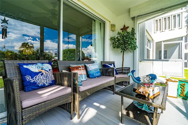 a outdoor living room with furniture and a potted plant