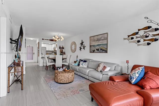 a living room with furniture a rug and a chandelier