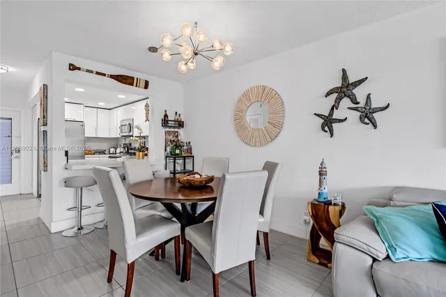 a view of a dining room with furniture and chandelier