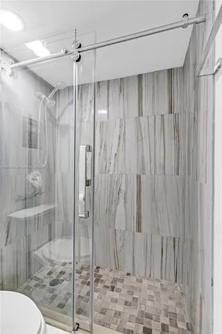 a bathroom with a shower and a toilet