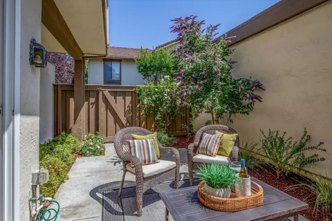 a view of balcony with furniture and a potted plant