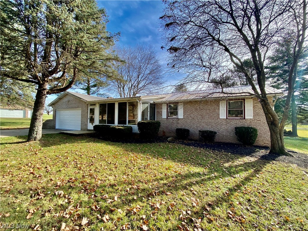 23551 Sandy Creek Road Minerva, OH 44657 - Photo 1 of 35 Ranch-style home featuring a front lawn and a garage