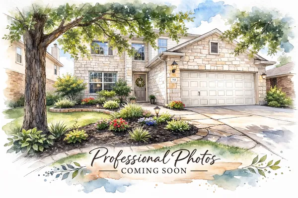 a front view of a house with a yard and potted plants