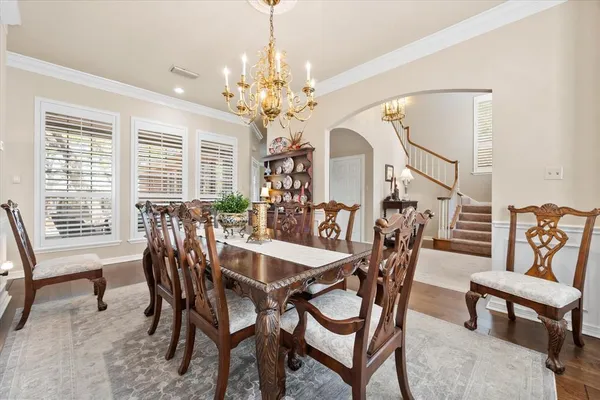 a view of a dining room with furniture and chandelier