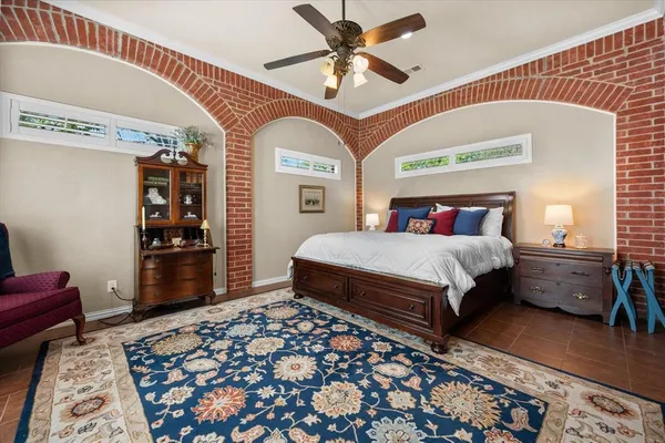 a bedroom with furniture and a large window