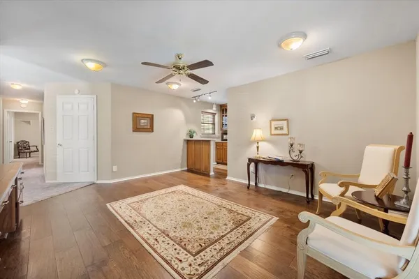 a living room with hard wood floors and a rug