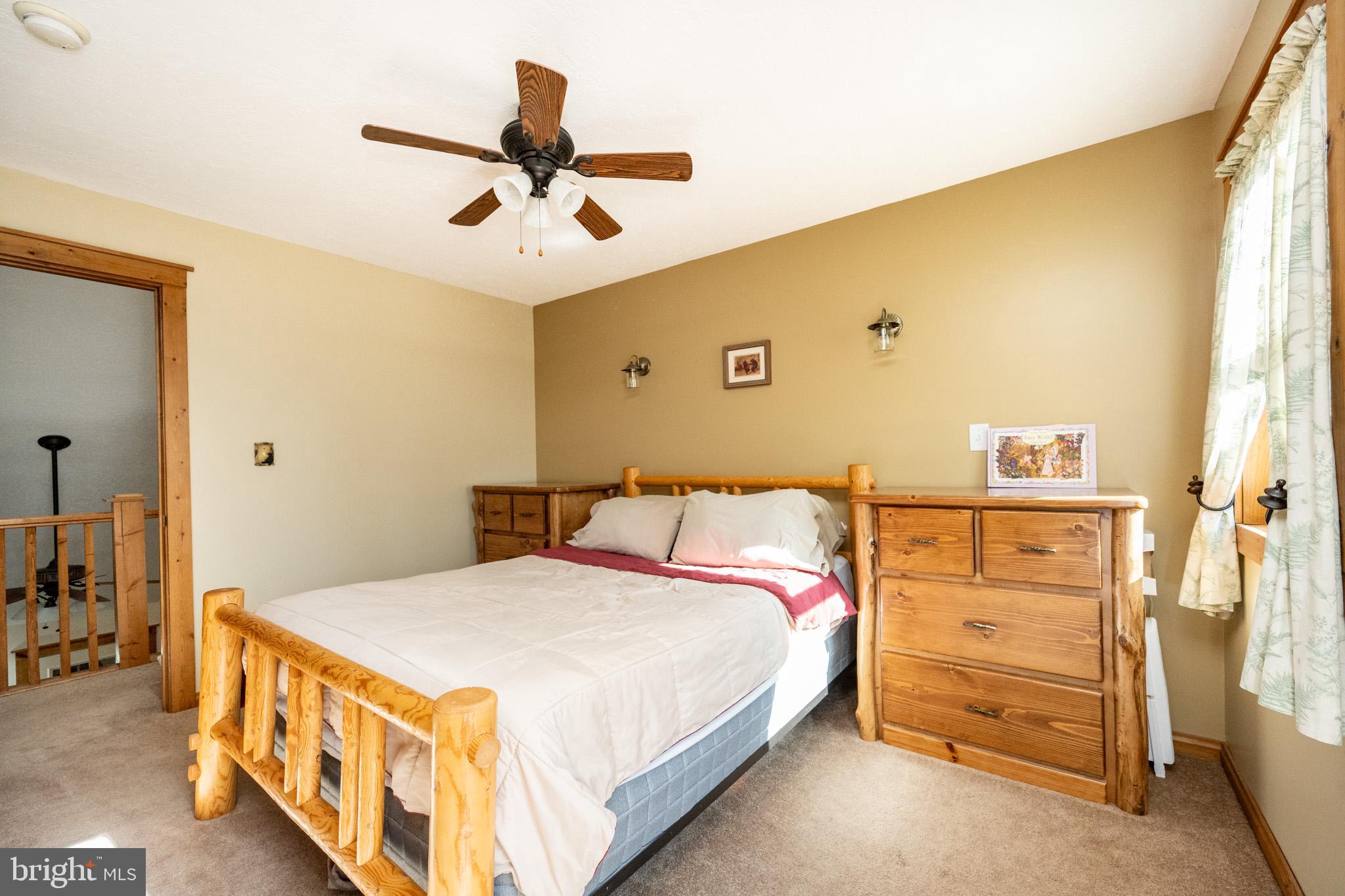 328 Stool Rock Road Oakland, MD 21550 - Photo 71 of 133 a bedroom with a bed and a walk in closet