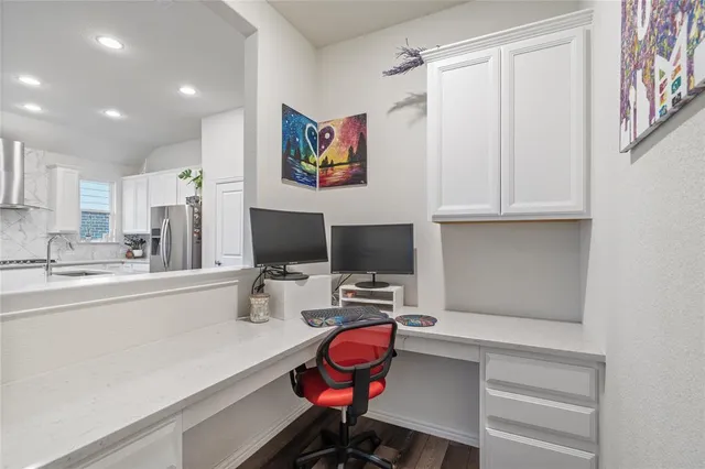 a view of a workspace with furniture and gym equipment