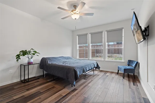 a bed room with a bed and a chair