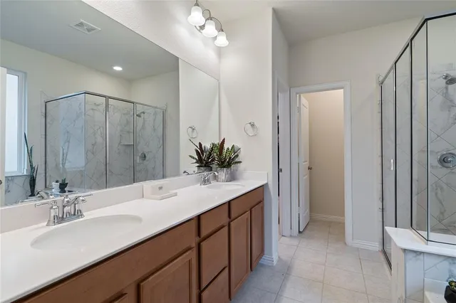 a bathroom with a double vanity sink a and a mirror