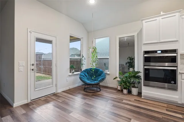 a room with furniture and potted plants