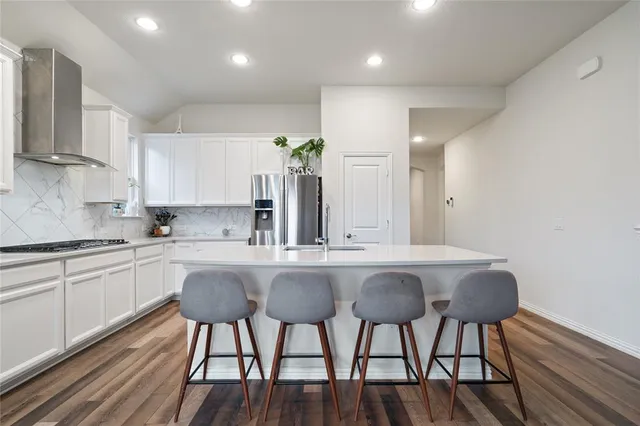 a kitchen with a table chairs stove and cabinets