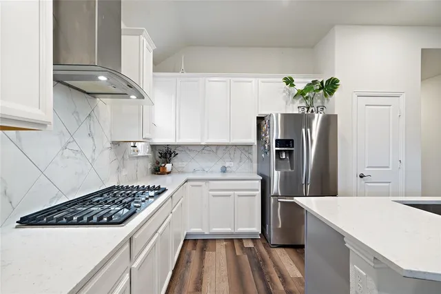 a kitchen with stainless steel appliances a sink stove and refrigerator