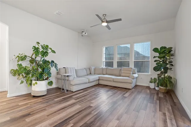a living room with furniture and a potted plant