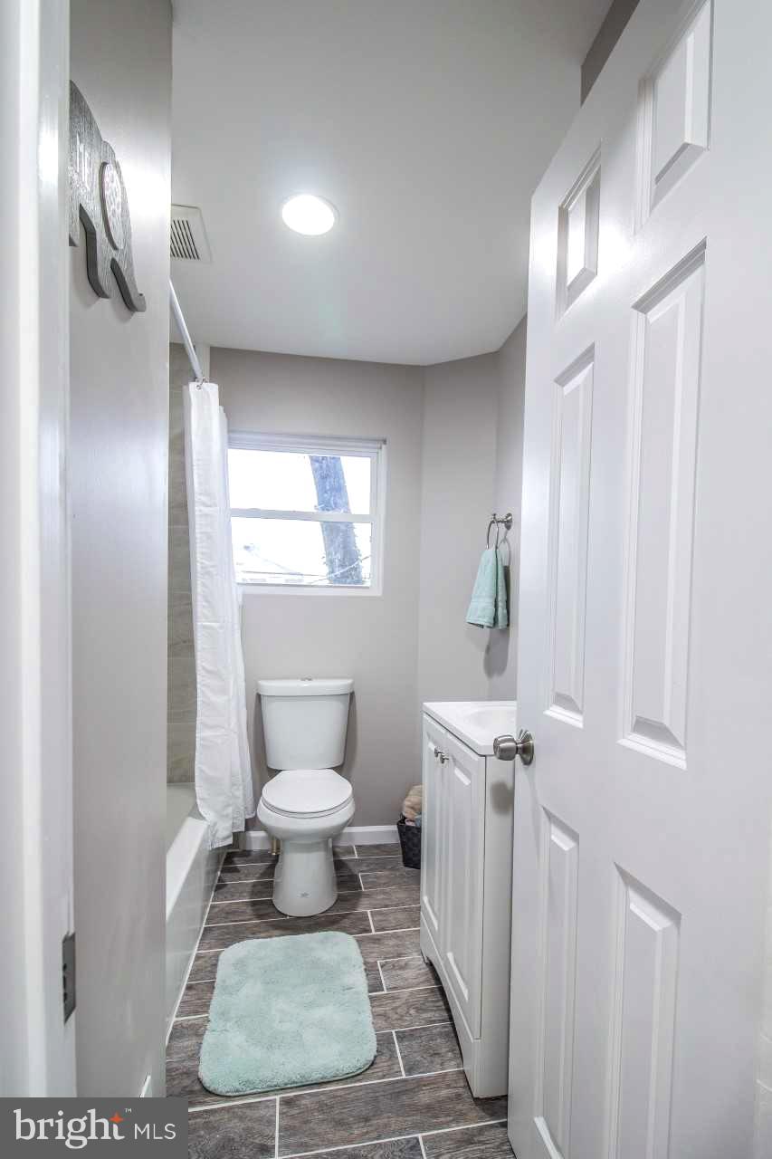 37 Northship Road Baltimore, MD 21222 - Photo 12 of 23 a bathroom with a toilet a sink and mirror