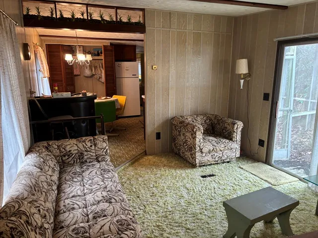 a bedroom with furniture and a large window