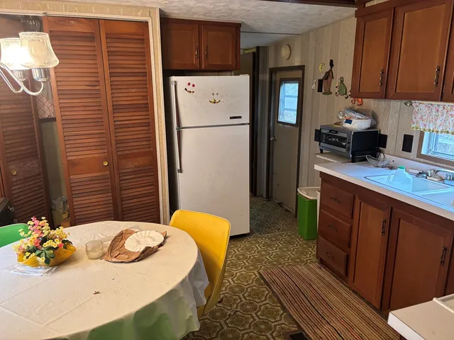 a kitchen with stainless steel appliances granite countertop a refrigerator a sink and dishwasher