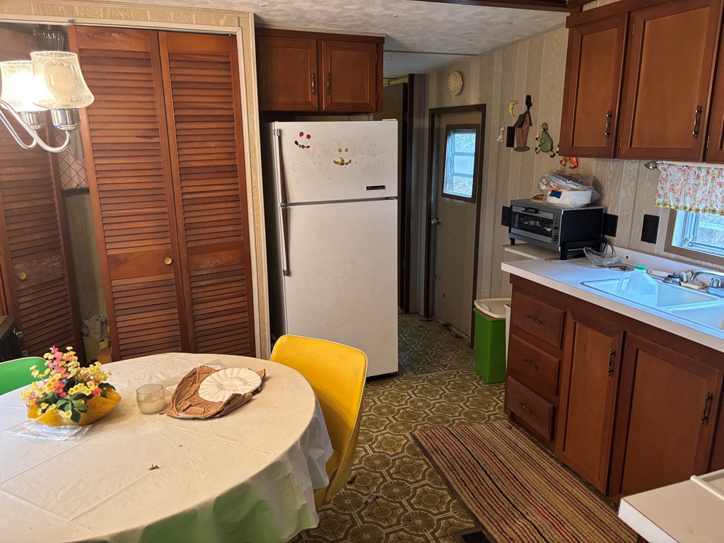 366 Gander Gap Road Hiawassee, GA 30546 - Photo 5 of 13 a kitchen with stainless steel appliances granite countertop a refrigerator a sink and dishwasher