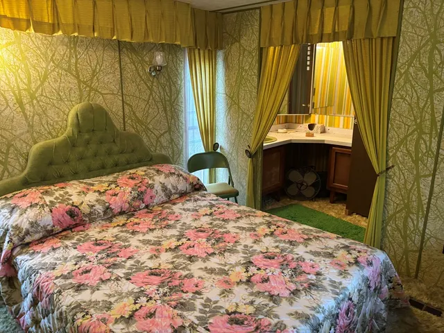 a bedroom with a bed and a fireplace