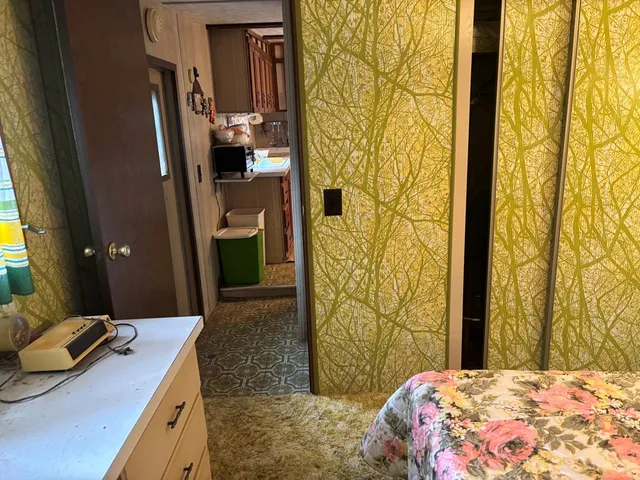 a bedroom with a bed and a bathroom