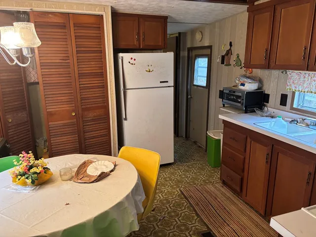 a kitchen with stainless steel appliances granite countertop a refrigerator a sink and dishwasher