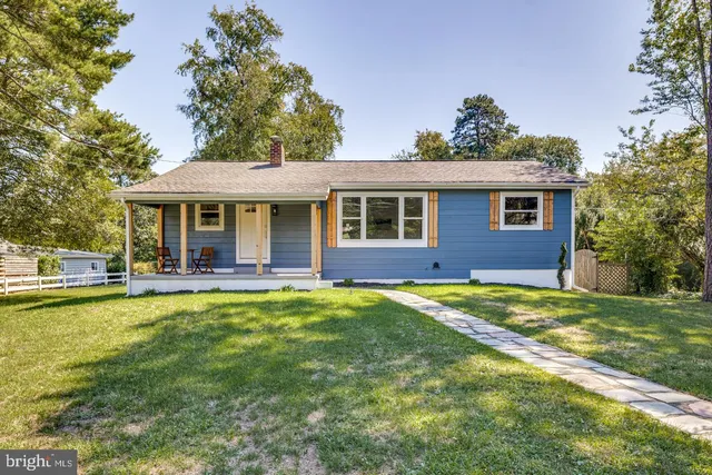 a view of a house with a swimming pool and a yard
