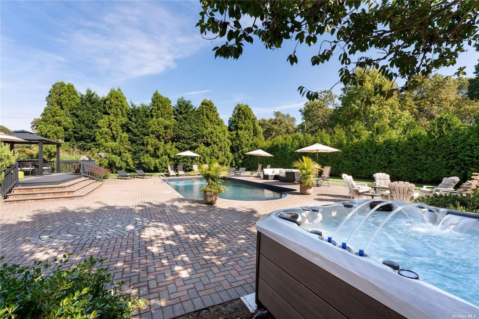60 Lynncliff Road Hampton Bays, NY 11946 - Photo 13 of 35 a view of a yard with plants and a sitting area