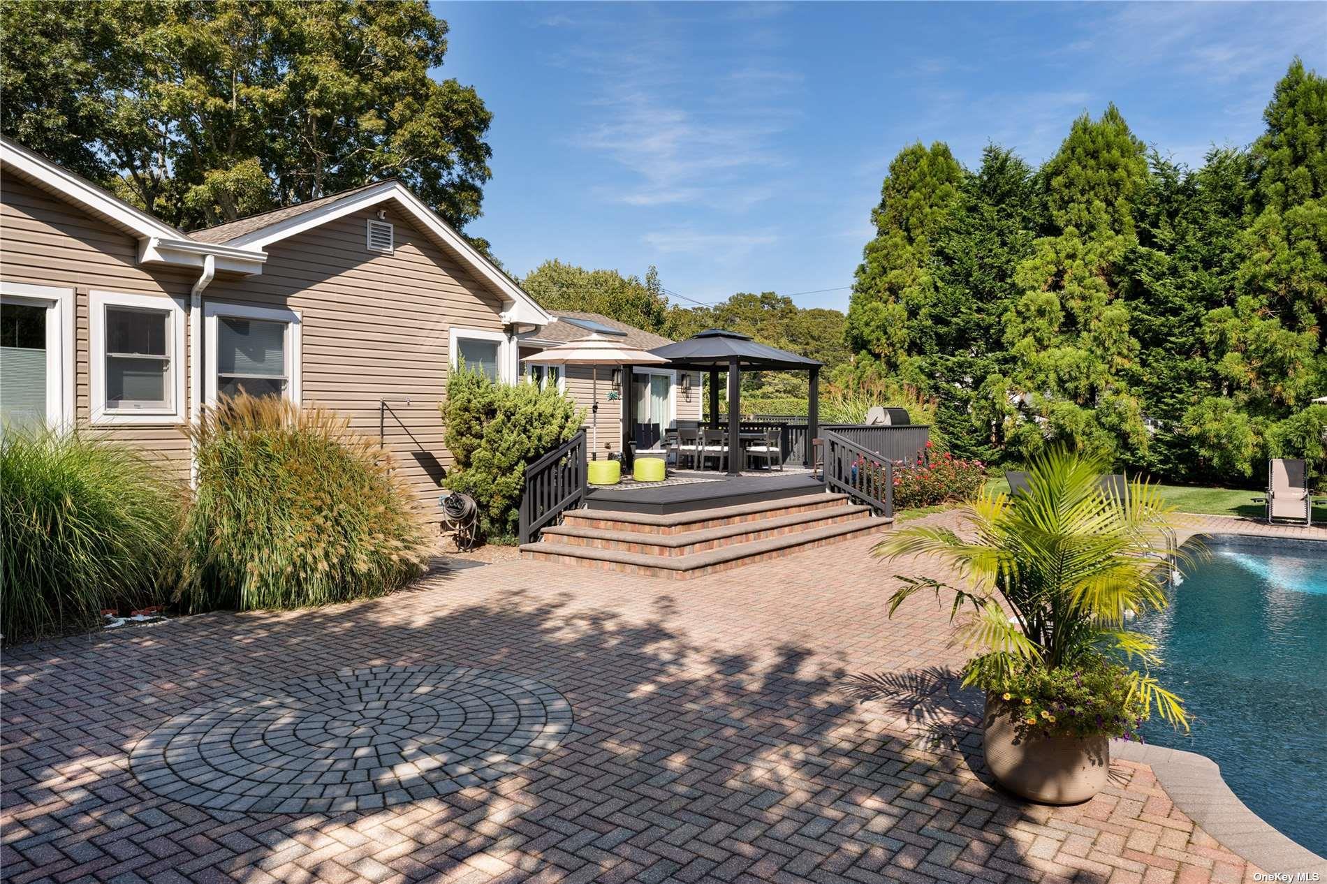 60 Lynncliff Road Hampton Bays, NY 11946 - Photo 16 of 35 a front view of a house with a yard