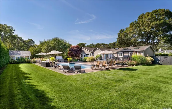 a view of a house with garden and a sitting area