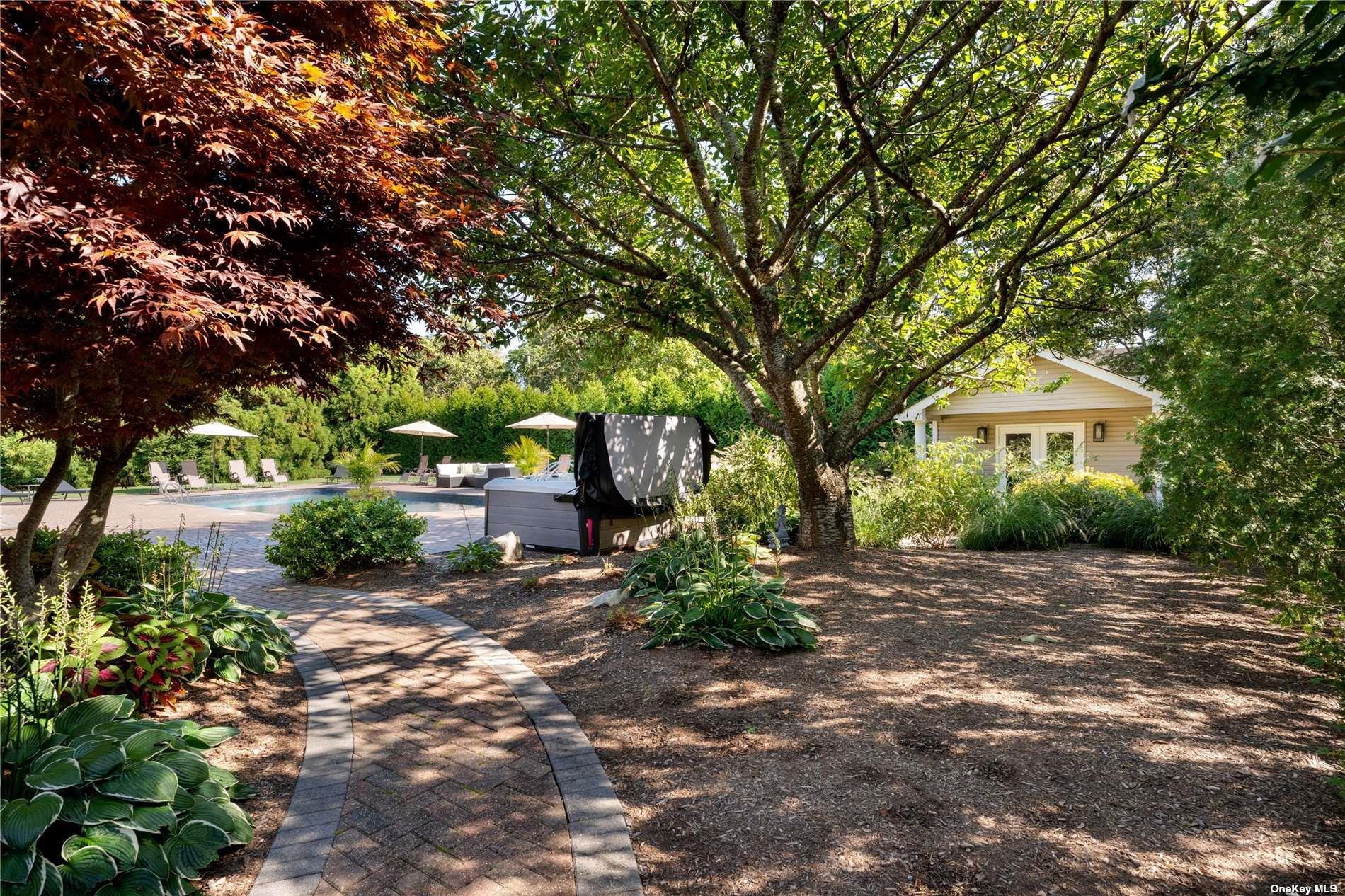 60 Lynncliff Road Hampton Bays, NY 11946 - Photo 20 of 35 a front view of a house with a yard