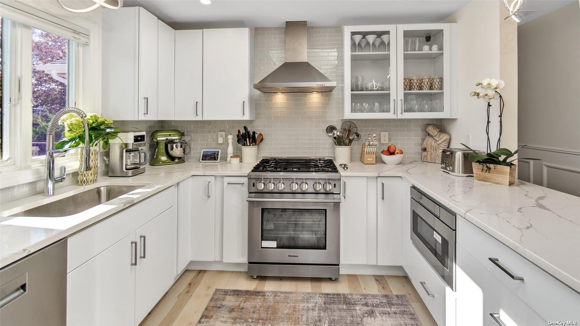 60 Lynncliff Road Hampton Bays, NY 11946 - Photo 22 of 35 a kitchen with granite countertop a stove sink and cabinets