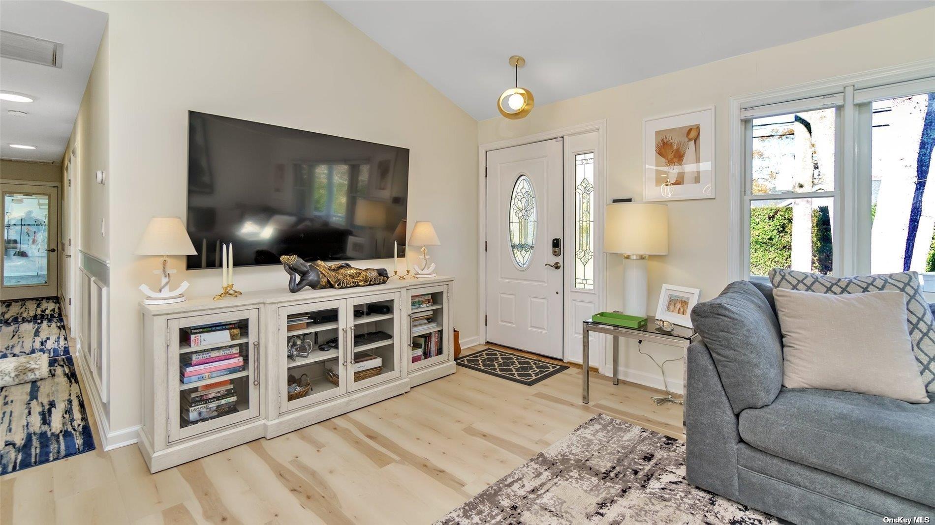 60 Lynncliff Road Hampton Bays, NY 11946 - Photo 28 of 35 a living room with furniture and a flat screen tv