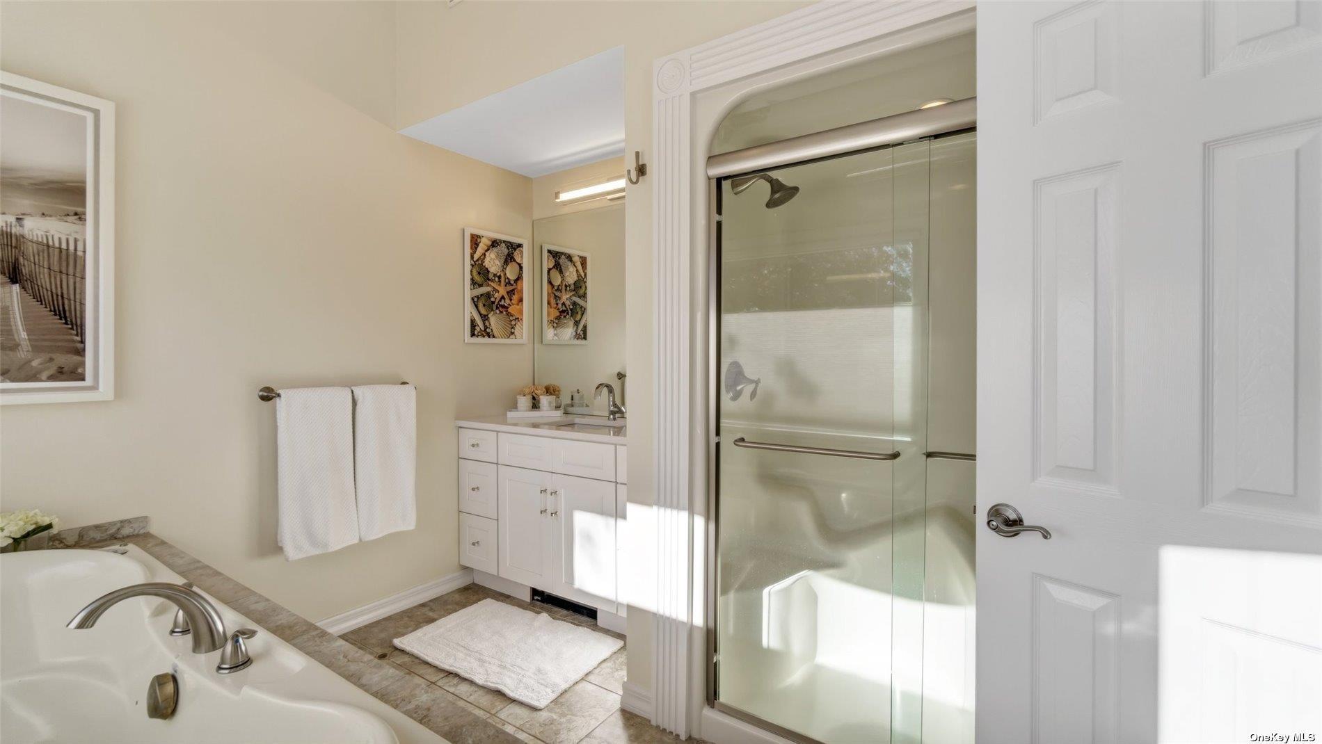 60 Lynncliff Road Hampton Bays, NY 11946 - Photo 30 of 35 a bathroom with a tub sink and mirror