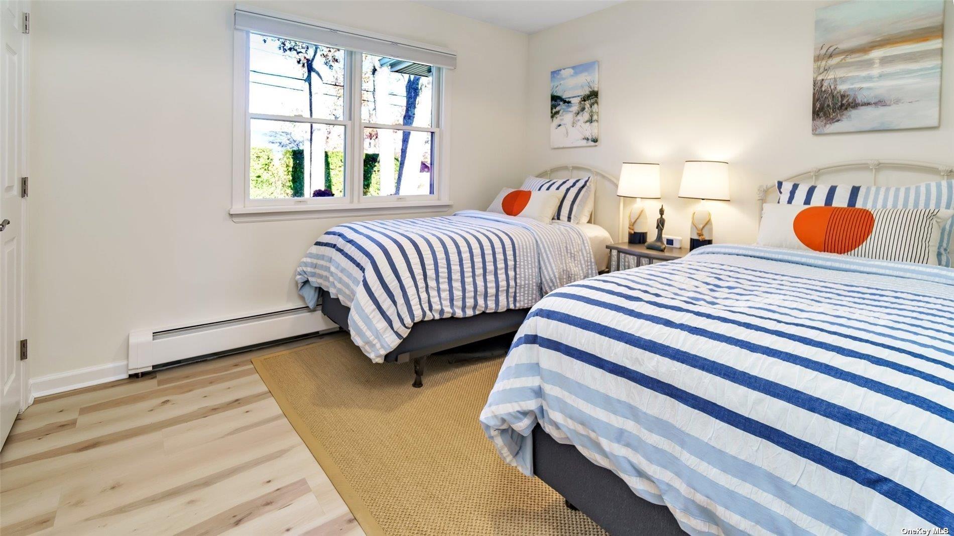 60 Lynncliff Road Hampton Bays, NY 11946 - Photo 31 of 35 a bedroom with two beds and a window