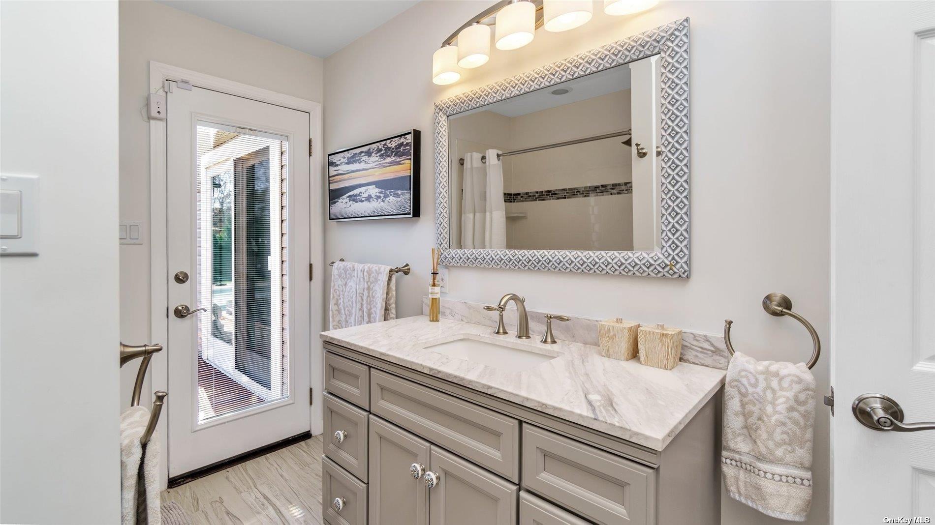 60 Lynncliff Road Hampton Bays, NY 11946 - Photo 32 of 35 a bathroom with a granite countertop sink vanity and mirror