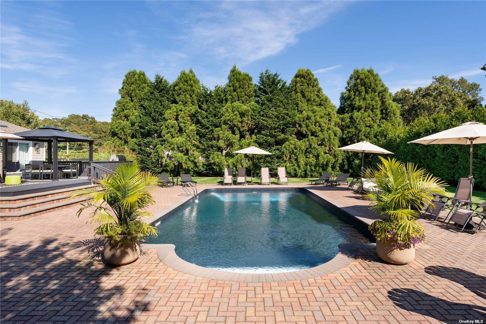 60 Lynncliff Road Hampton Bays, NY 11946 - Photo 4 of 35 a view of a swimming pool with a patio