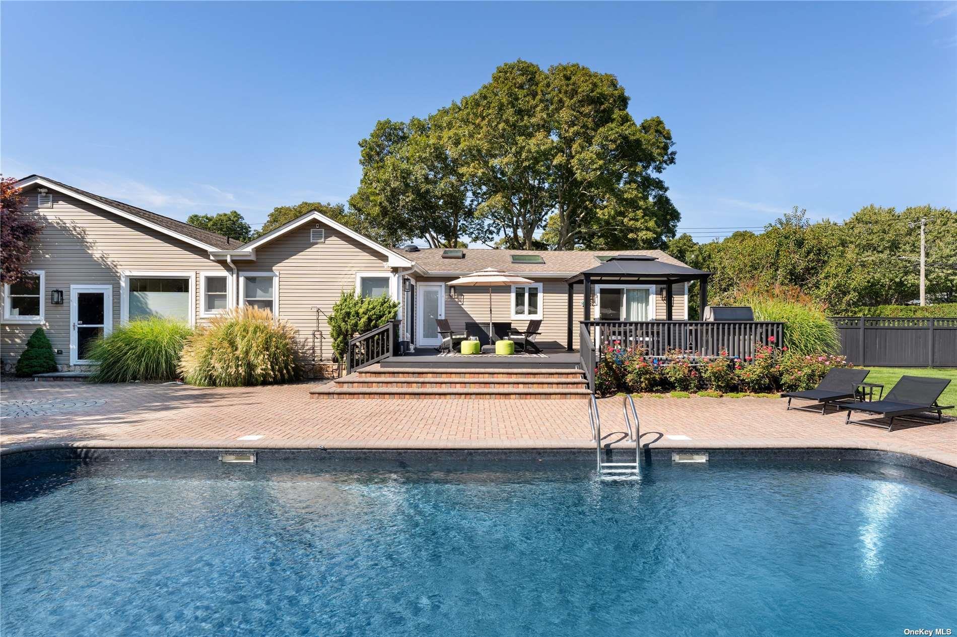 60 Lynncliff Road Hampton Bays, NY 11946 - Photo 6 of 35 a front view of a house with a yard