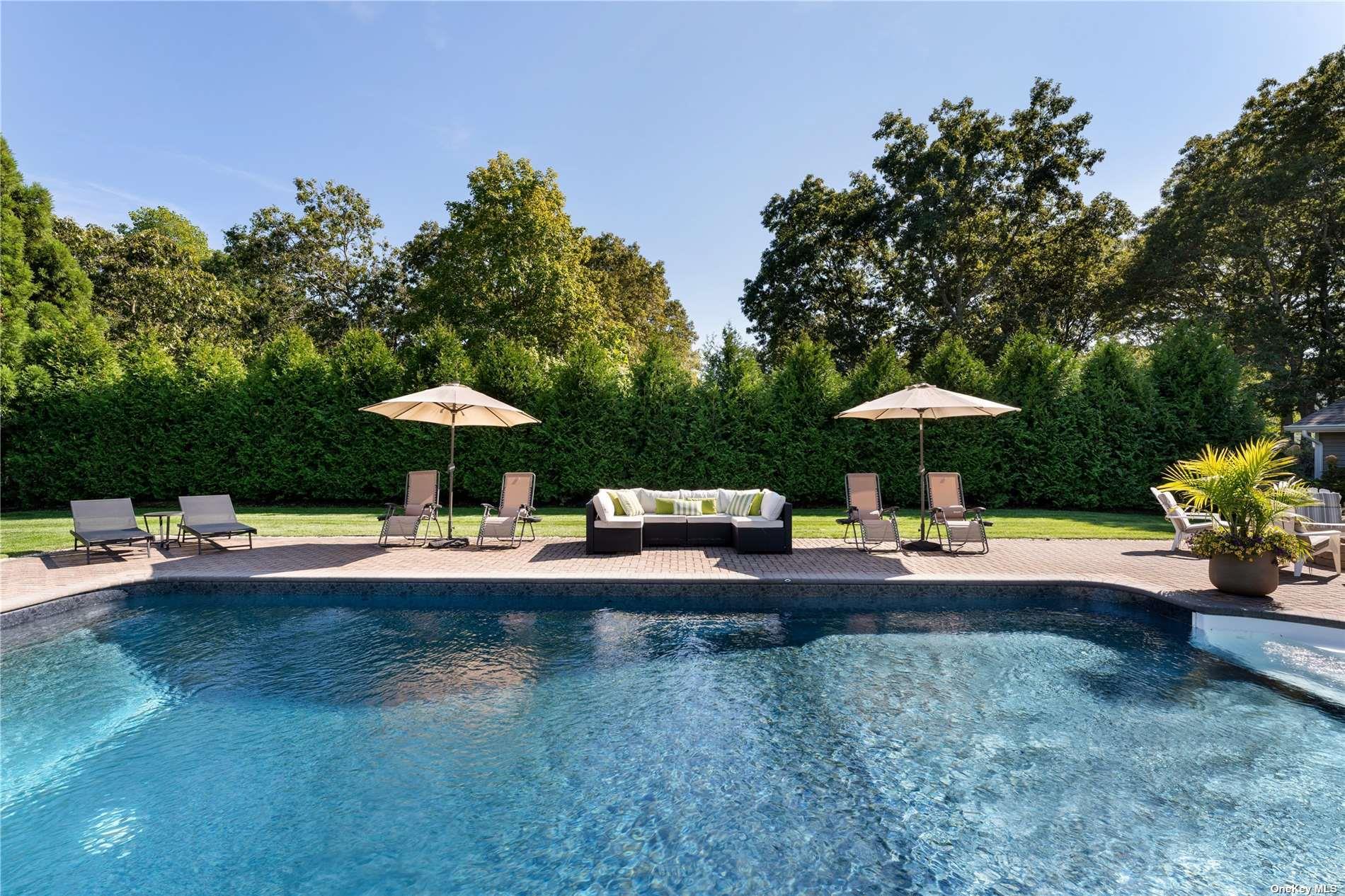 60 Lynncliff Road Hampton Bays, NY 11946 - Photo 7 of 35 a view of a swimming pool and lounge chairs