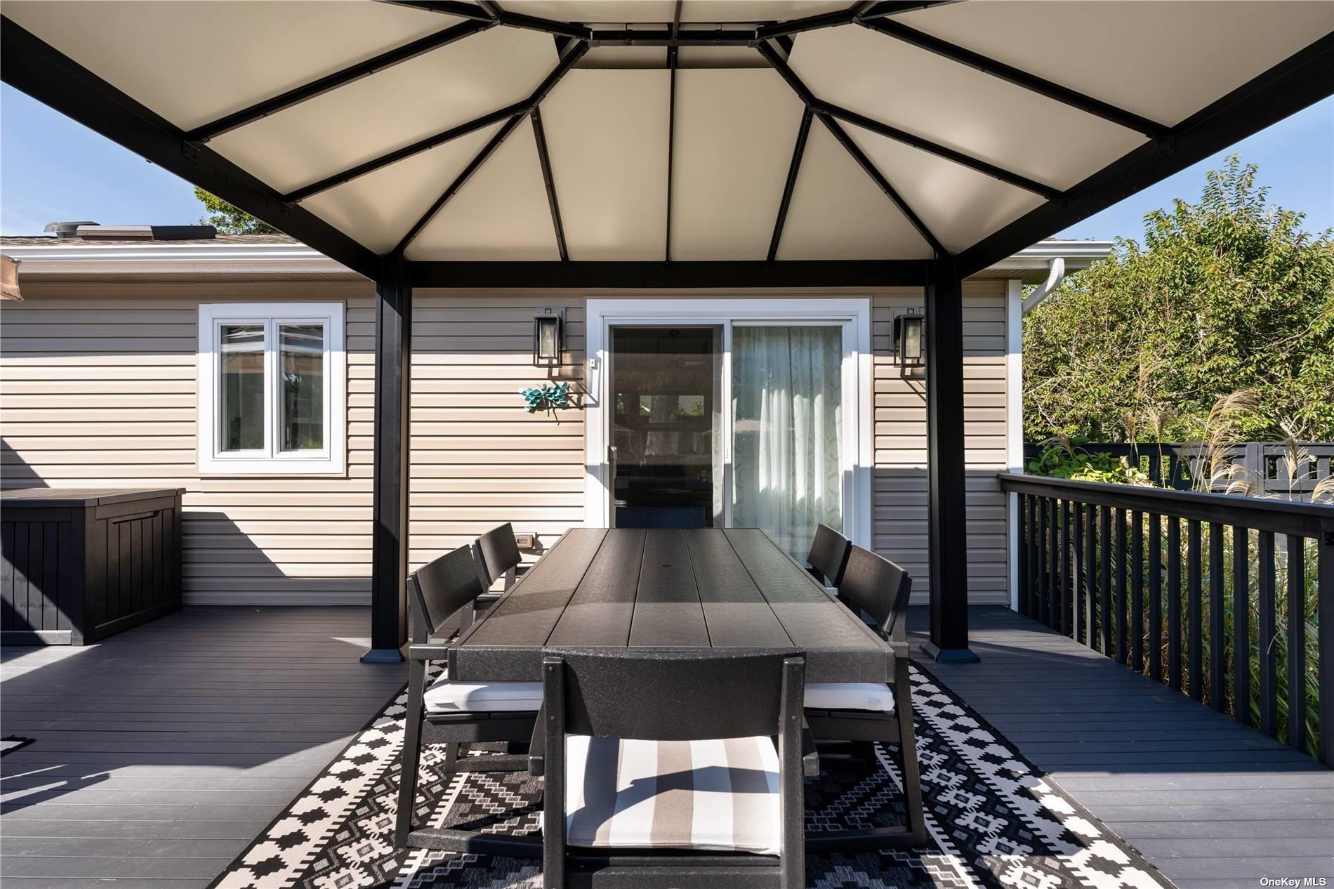 60 Lynncliff Road Hampton Bays, NY 11946 - Photo 10 of 35 a front view of a house with patio
