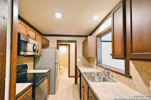a kitchen with stainless steel appliances granite countertop a sink and a stove