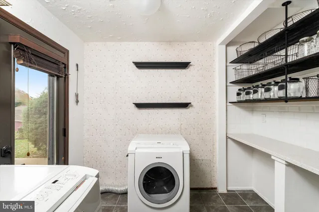 a view of a kitchen with washing machine and a sink
