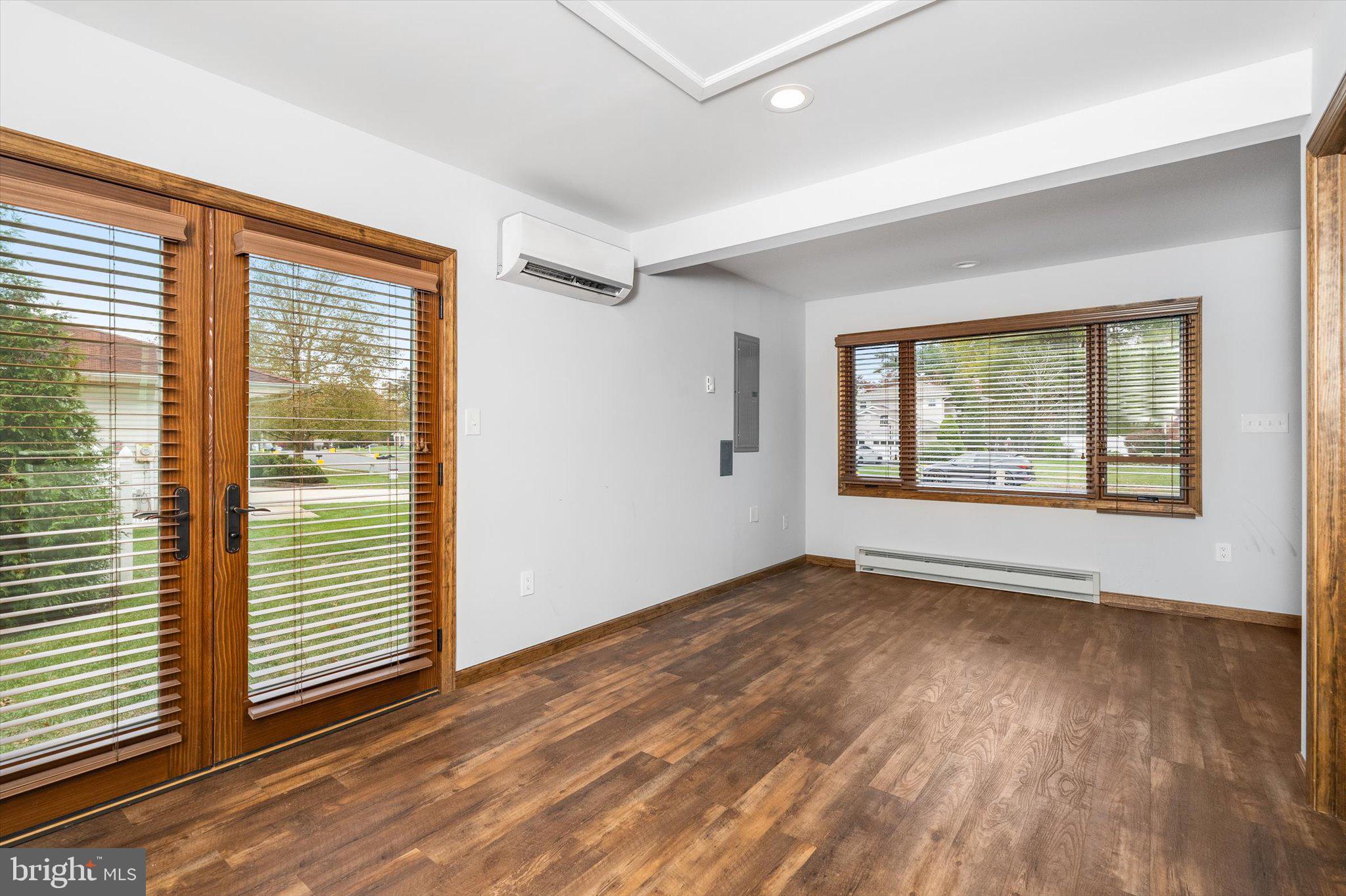87 Limewood Drive Hamilton, NJ 08690 - Photo 16 of 34 an empty room with wooden floor and windows