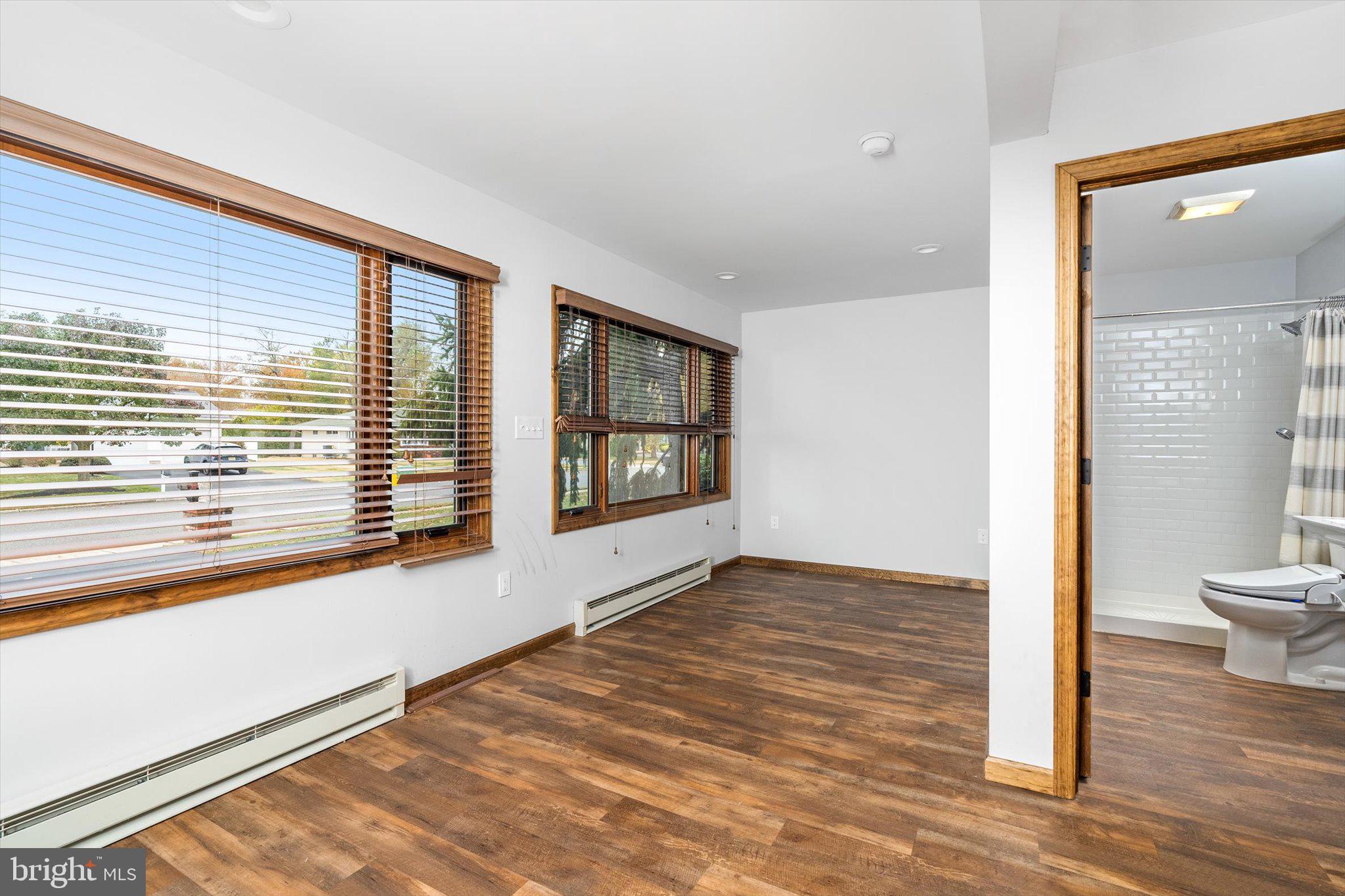 87 Limewood Drive Hamilton, NJ 08690 - Photo 17 of 34 a view of an empty room with a window and wooden floor