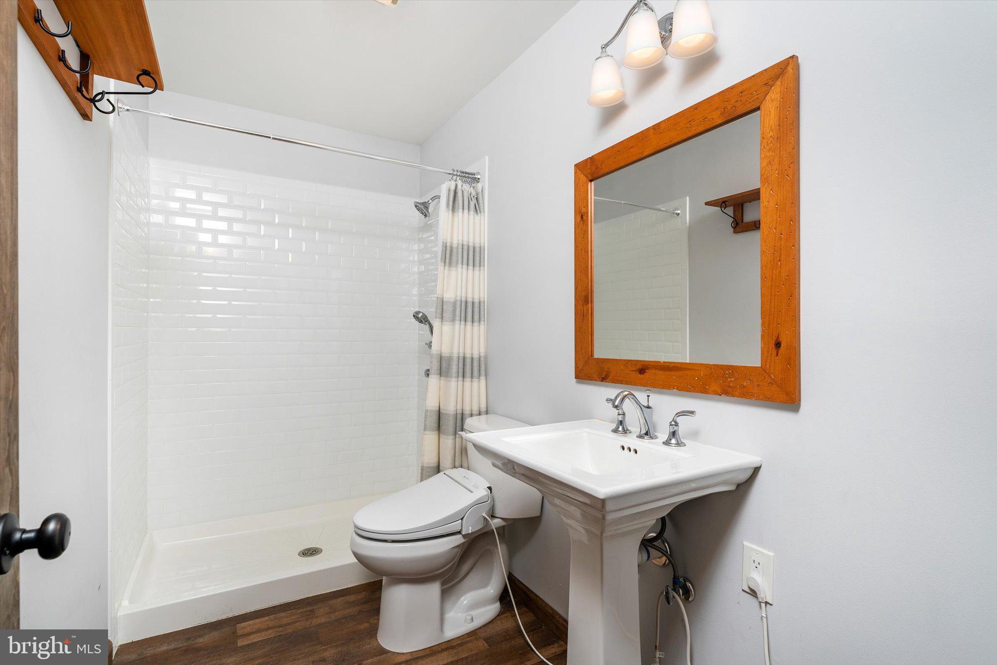 87 Limewood Drive Hamilton, NJ 08690 - Photo 19 of 34 a bathroom with a sink a toilet and shower