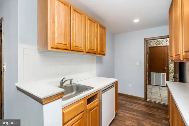 a kitchen that has a sink and a stove in it