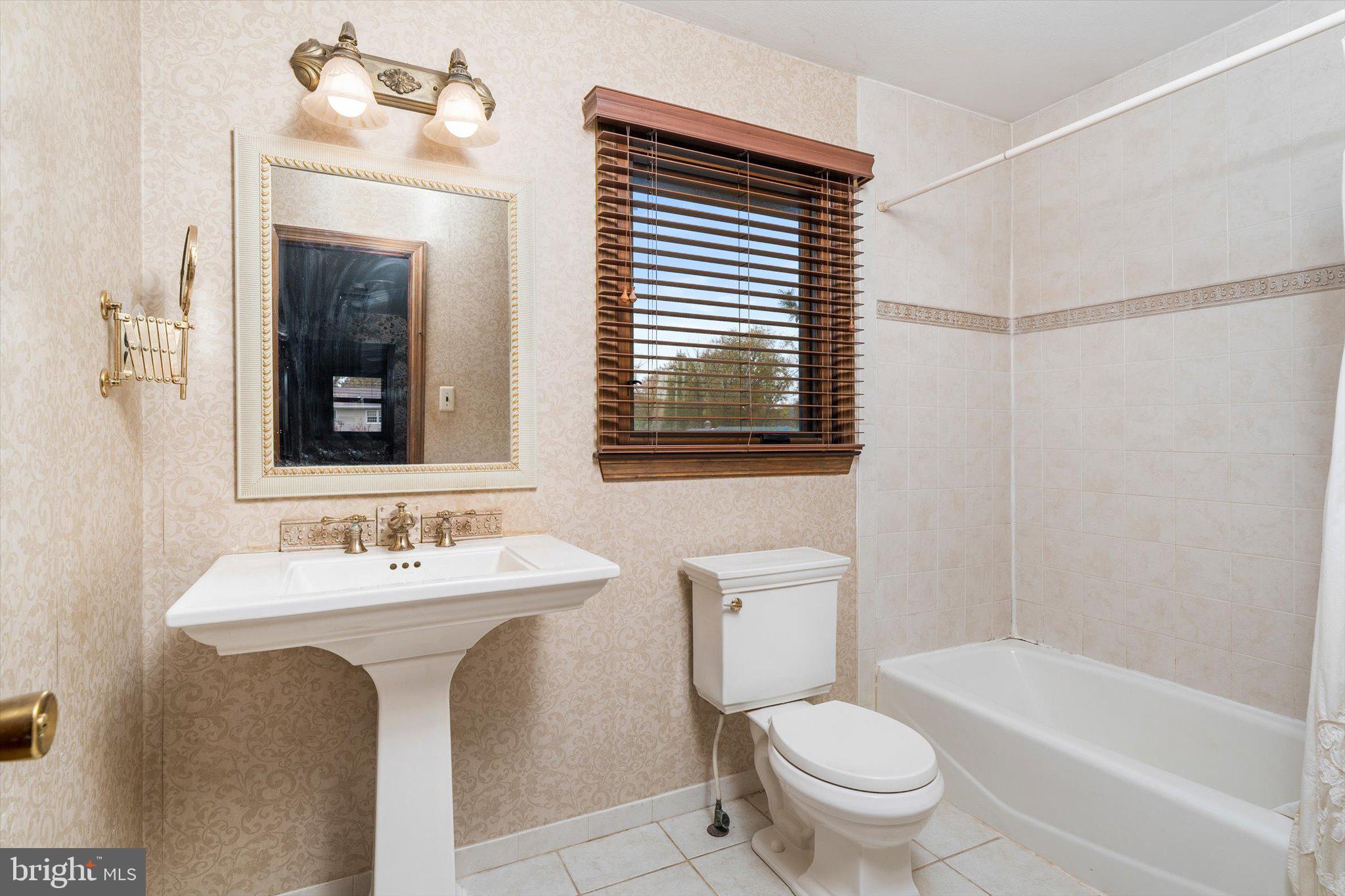 87 Limewood Drive Hamilton, NJ 08690 - Photo 22 of 34 a bathroom with a sink toilet mirror and shower
